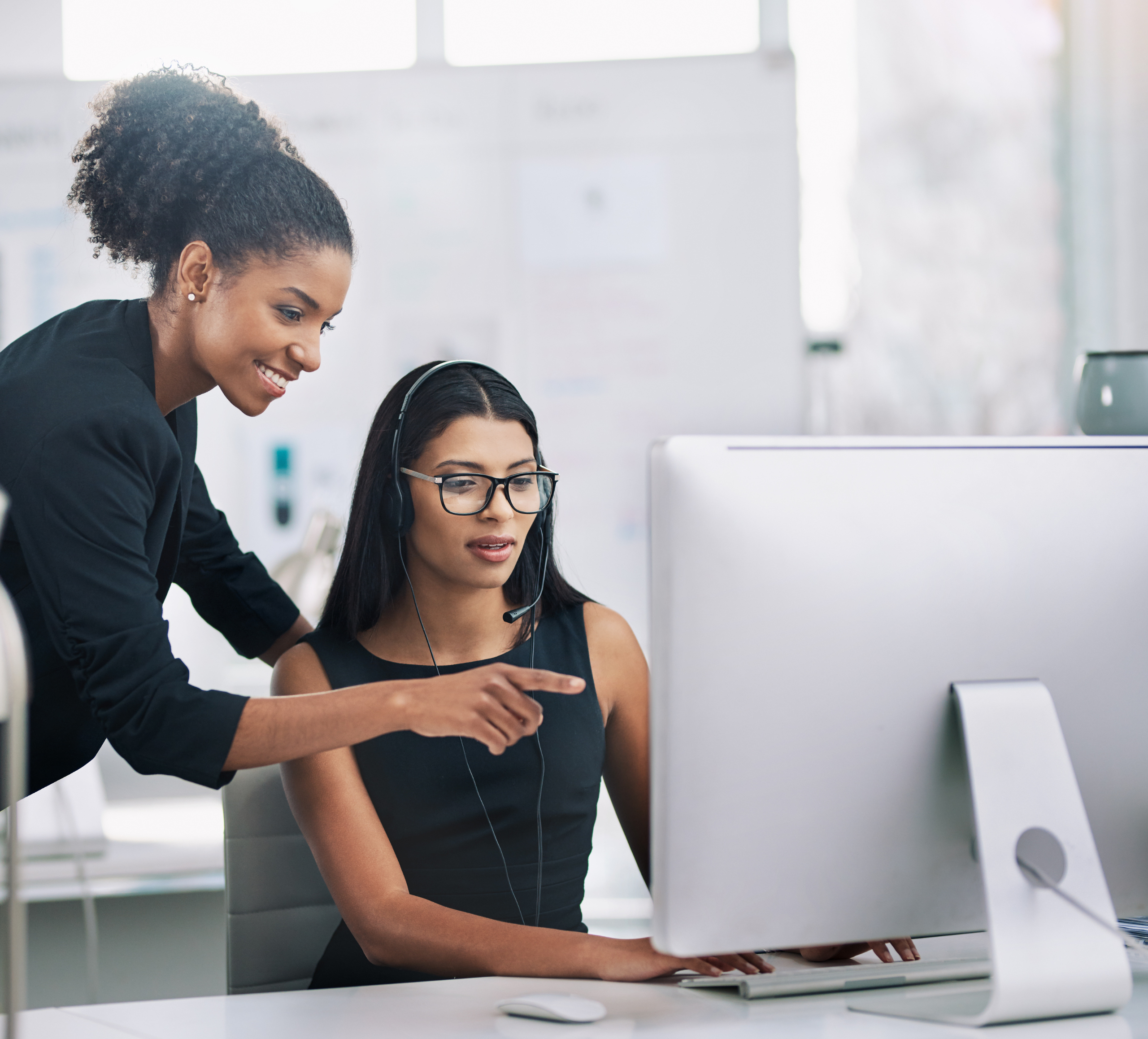 Women helping coworker Women helping coworker